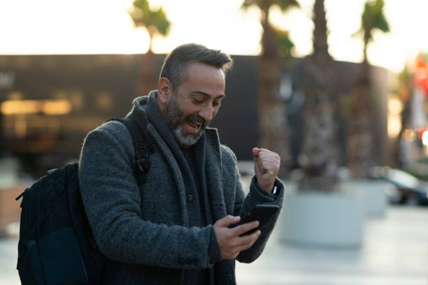 istock Ecstatic businessman learning good news on smartphone 1295116617