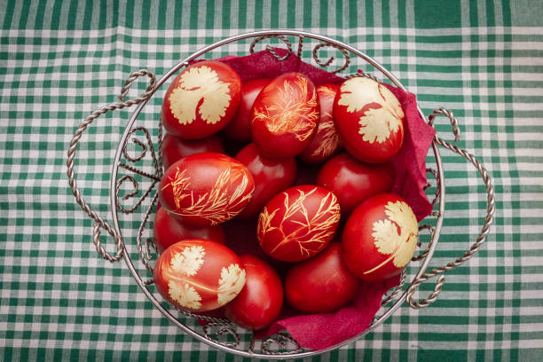 istock Painted Easter eggs in onion husks with abstract drawings are in a basket 1295118942