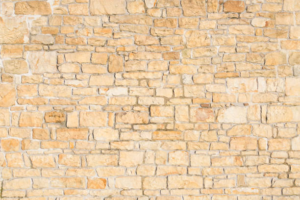 istock old sandstone wall stacked and placed with cement. stone background. copy for space and text. 1295128609