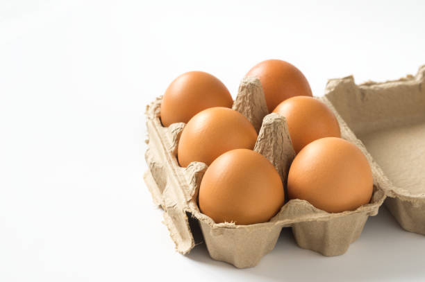 istock Eggs in carton box on white background. 1295132112