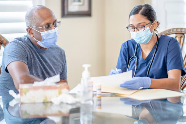 istock Female nurse does home consultation with patient 1295132257