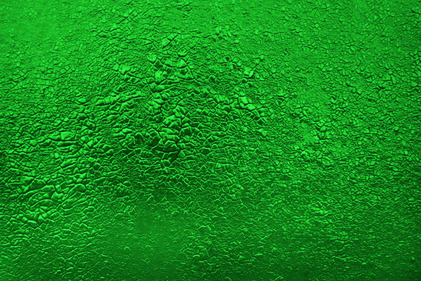 istock Green background. Green texture. cracked paint texture 1295133246