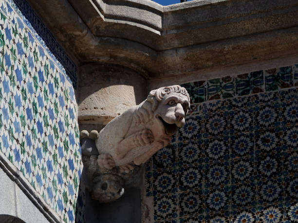Lion statue on a decorative tile wall. Portugal