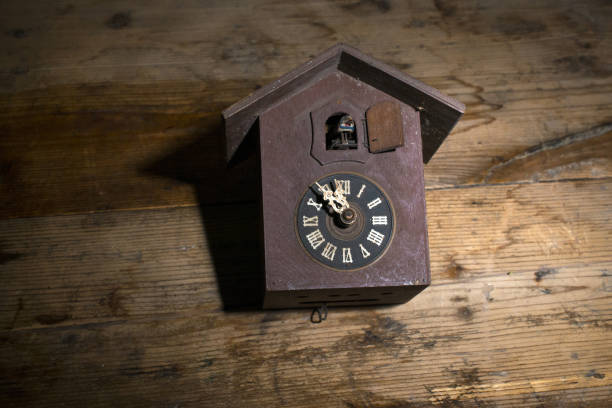 Solid woodcut carved antique cuckoo wall clock on wood background ,time concept image