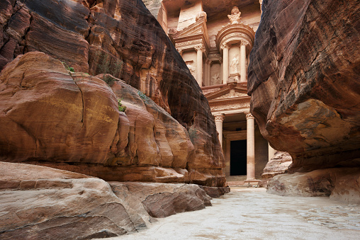Narrow passage of rocks. First sight on Temple Khazneh when you enter in Petra, Jordan