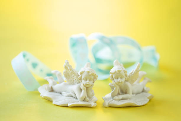 istock two angels and heart ribbon 1295147733