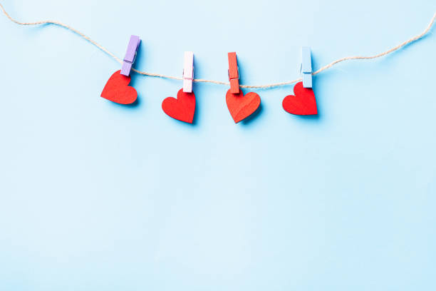 istock red heart-shaped valentines decoration hanging with wood clips 1295148907