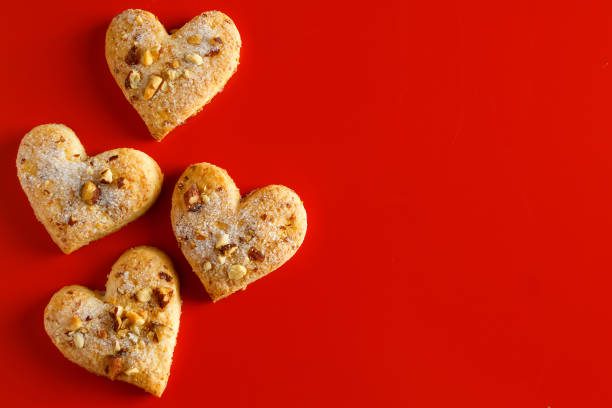 istock Heart shaped sugar cookies on red background 1295151019