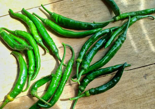istock green curly chilies on a wooden plank background 1295152174