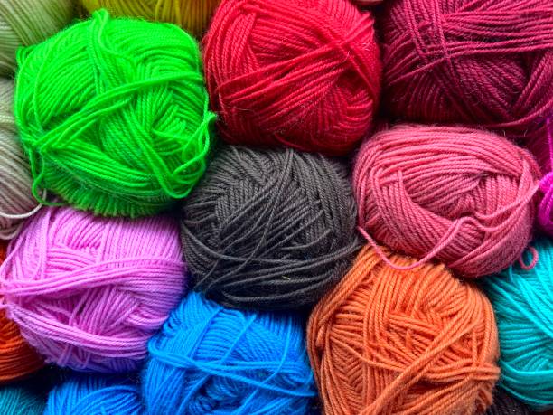 istock Tangles of thin acrylic yarn. Tightly stacked with a multicolored background. 1295152413