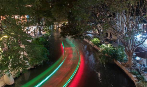 istock Long exposure of boat on river walk at night 1295170561