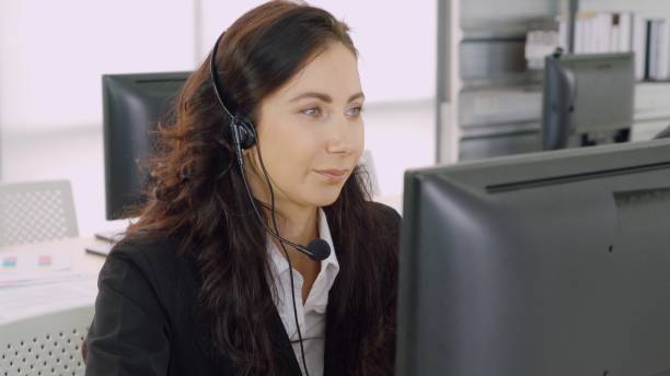 istock Business people wearing headset working in office 1295175665