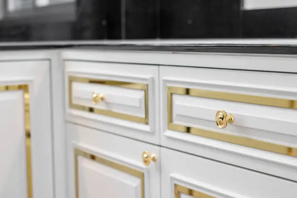 Photo of Close up of white kitchen faucet and sink