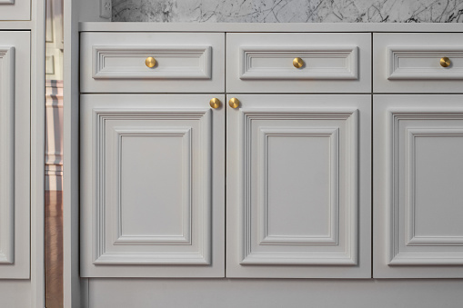 Close-up of the room's white wood cabinets
