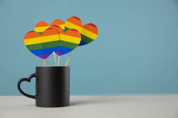 istock LGBTQ coffee mug community rainbow hearts colors, coffee mug 1295185305