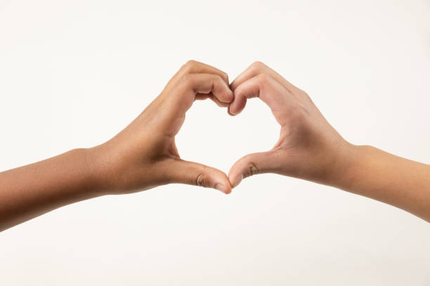 istock dark and white hands making a heart sign 1295188450
