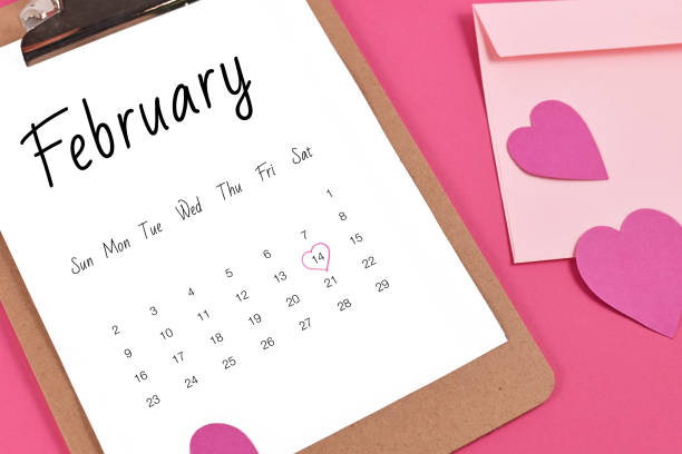 istock February calendar sheet with Valentine's Day on the 14th marked with heart surrounded by hearts and love letter 1295191682