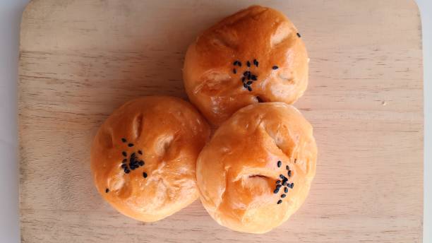 istock Taro filled bun on wood background. 1295195345