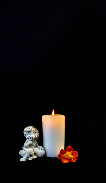 istock Candle on a black background, postcard, Flat Lai on death and funeral 1295196521
