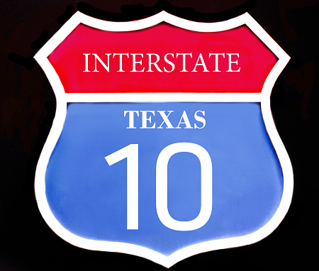 Interstate red blue road sign US state Texas 10 close up isolated on black background. 3d illustration