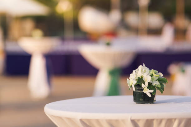 istock a glass vase with flowers on the white reception table at beachfront weddings party even 1295205379