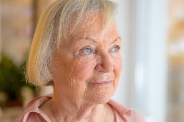 istock Lonely elderly woman standing reminiscing 1295207092