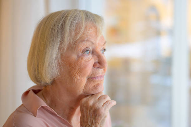 istock Thoughtful elderly lady with hand to chin 1295207112