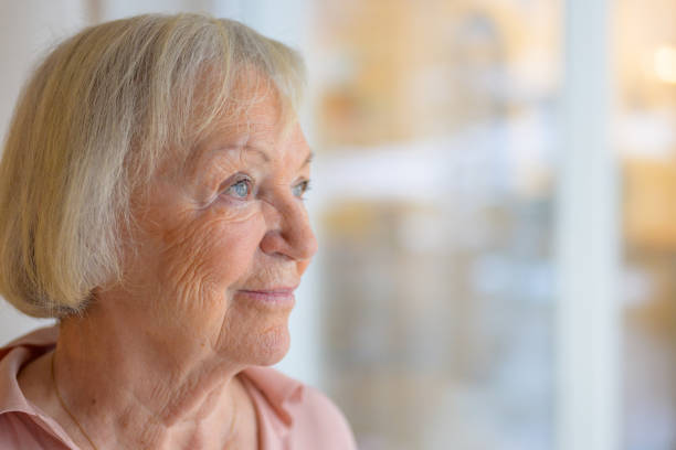istock Contented senior woman smiling to herself 1295207209