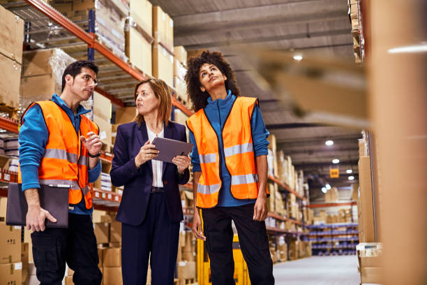 istock A manager with two warehouse workers inspecting the merchandise. 1295207905