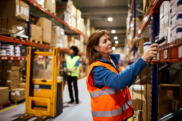 istock Middle aged female worker scanning products on a shelf. 1295208129