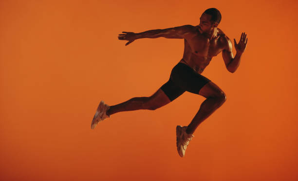 istock Bare chested male athlete running 1295210834
