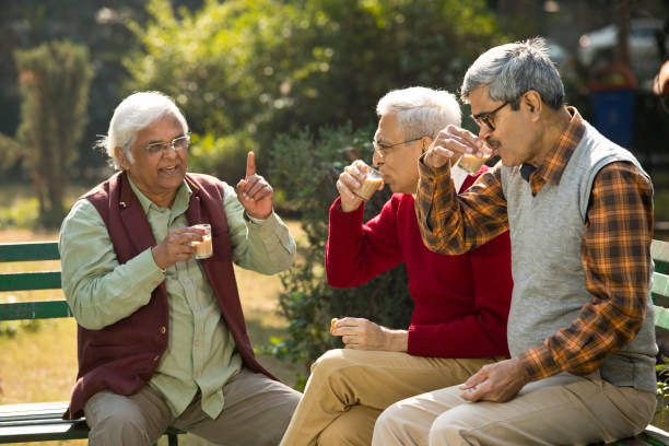 istock Senior men enjoying hot tea at park 1295215071