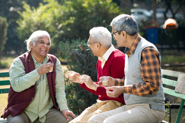 istock Senior men enjoying hot tea at park 1295215123