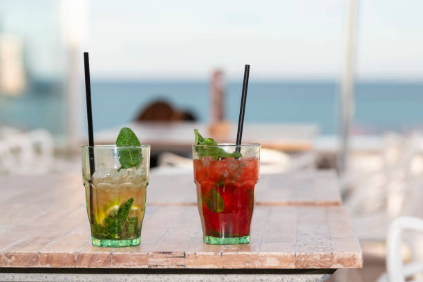 istock Appetizing cocktails on a wooden table outdoors 1295215146