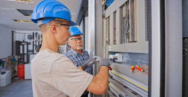 istock Electrician teaching his apprentice to connect the wires 1295215857