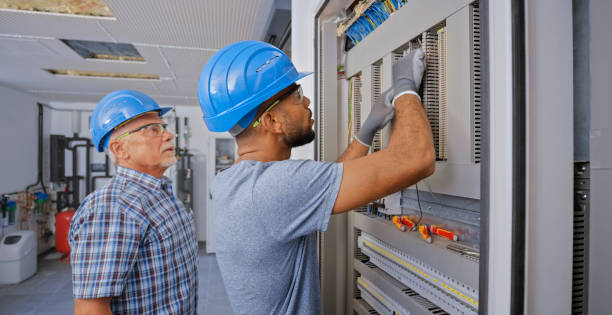 istock Electrician teaching his apprentice to connect the wires 1295215894