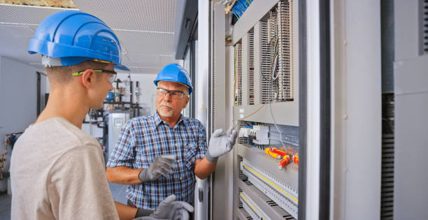 istock Electrician teaching his apprentice to connect the wires 1295215898