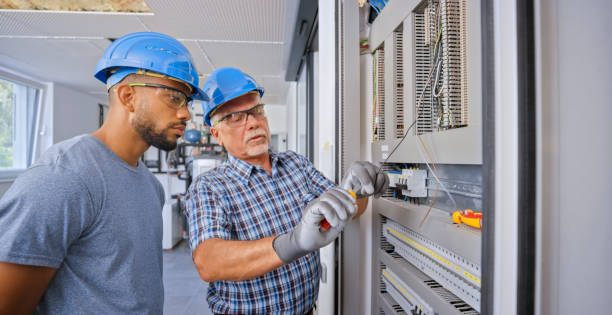 istock Electrician teaching his apprentice to connect the wires 1295215914