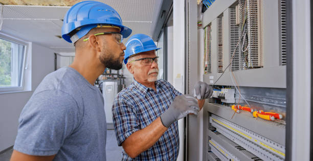 istock Electrician teaching his apprentice to connect the wires 1295215926