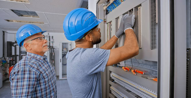 istock Electrician teaching his apprentice to connect the wires 1295215935