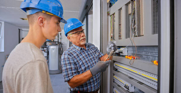 istock Electrician teaching his apprentice to connect the wires 1295215974