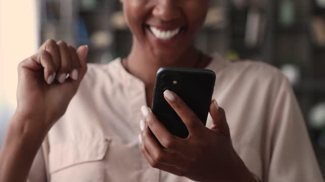 Close up of african woman hands holding smart phone