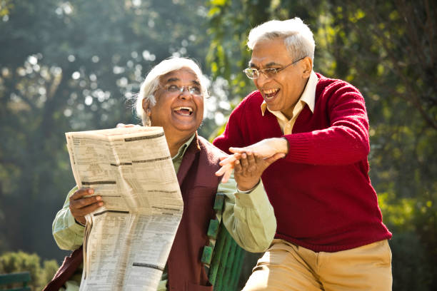 istock Two senior men having fun reading newspaper 1295217522