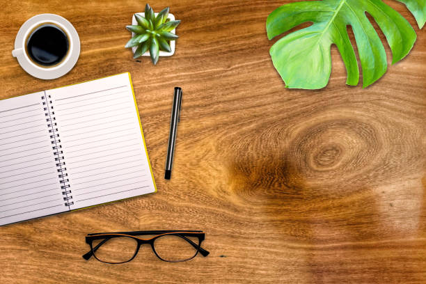 istock Office desk notebook pen with accessories and coffee cups Top view with copy space. 1295219288