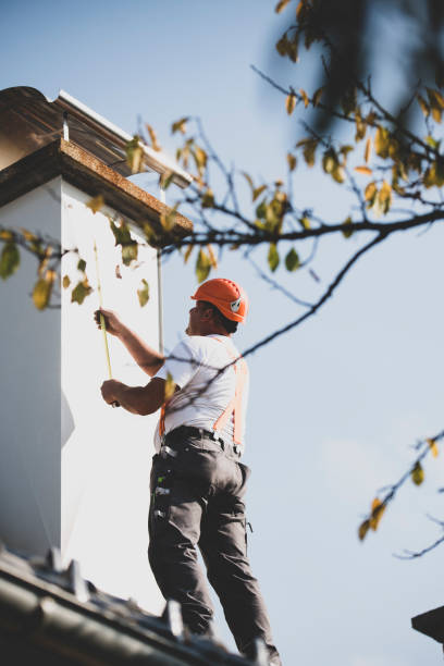 istock Roofer measuring chimney on roof top 1295220912