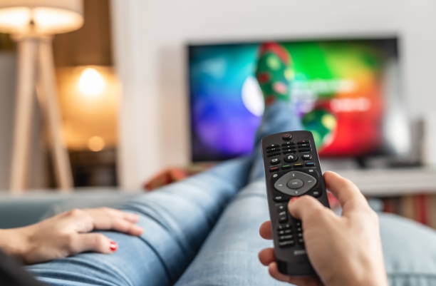 istock Woman watching tv at home. 1295222848