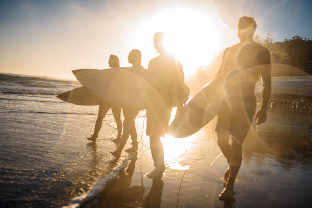 istock Burleigh Heads Surfers Walking on Beach with Boards at Dawn 1295227264