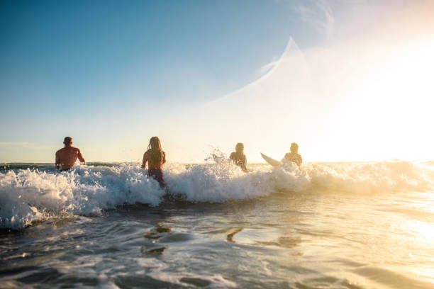 istock Gold Coast Surfers Running into Mist and Waves at Sunrise 1295227268