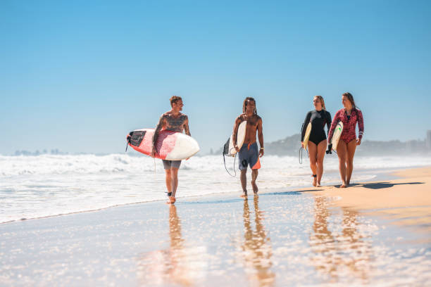 istock Gold Coast Surfers Walking with Boards at Water’s Edge 1295227343