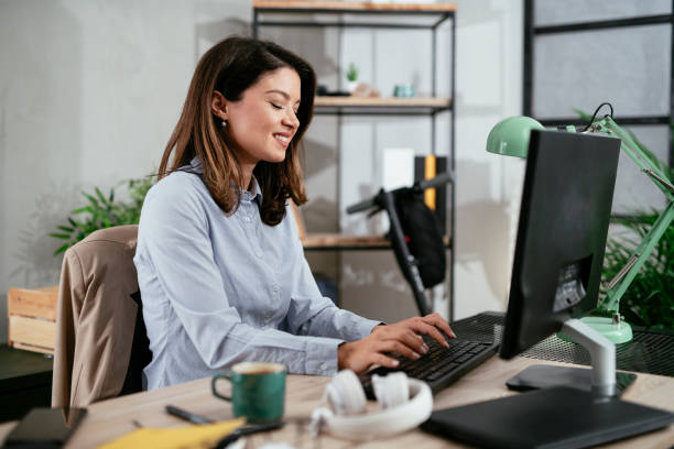 istock Beautiful young woman working on computer at her workplace 1295229068